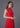 Qipology bridal - Sleeveless Wedding Qipao in classic red, featuring a mandarin collar in A-line silhouette; perfect for tea ceremony and evening banquet. (half body side view front picture)